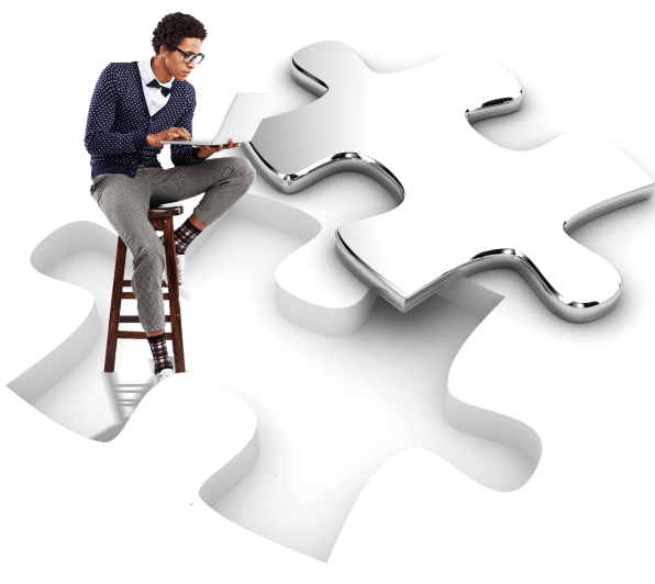 A man working on a laptop inside of a puzzle piece